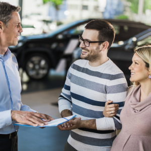 Couple purchasing car from dealership